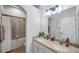 Bathroom with double sinks, and a bathtub with a sliding glass door at 5518 72Nd E Ter, Ellenton, FL 34222