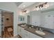 Bright bathroom featuring double sink vanity, modern lighting fixtures, and walk-in closet at 5518 72Nd E Ter, Ellenton, FL 34222