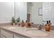 Bathroom featuring a dual-sink vanity with modern faucets, ample counter space, and stylish decor at 5518 72Nd E Ter, Ellenton, FL 34222