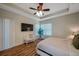 Spacious bedroom features a fan and a television set at 5518 72Nd E Ter, Ellenton, FL 34222