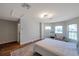 A view of a bedroom with windows and hardwood flooring at 5518 72Nd E Ter, Ellenton, FL 34222