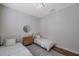 Bedroom featuring two twin beds, wood floor, modern chandelier, and a window at 5518 72Nd E Ter, Ellenton, FL 34222