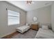 Bedroom featuring two twin beds, wood floor, and modern chandelier at 5518 72Nd E Ter, Ellenton, FL 34222