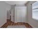 Bedroom with wood floor, a window and closet at 5518 72Nd E Ter, Ellenton, FL 34222