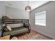Bedroom featuring bunkbed, wood floor, modern light fixture, and a window at 5518 72Nd E Ter, Ellenton, FL 34222