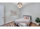 Bright bedroom with wood floors, recessed lighting, a decorative chandelier, and a map on the wall at 5518 72Nd E Ter, Ellenton, FL 34222