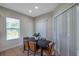 The dining room has a modern table, natural light, and a door to the outside at 5518 72Nd E Ter, Ellenton, FL 34222