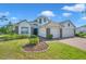 Beautiful home with manicured landscaping, stone accents, and a three-car garage at 5518 72Nd E Ter, Ellenton, FL 34222