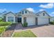 Charming home featuring a well-kept lawn, stone accents, and brick paver driveway at 5518 72Nd E Ter, Ellenton, FL 34222