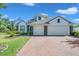 Well-maintained home with a brick driveway, lush lawn, and charming curb appeal at 5518 72Nd E Ter, Ellenton, FL 34222