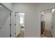 Hallway featuring bedroom, laundry area with modern washer and dryer at 5518 72Nd E Ter, Ellenton, FL 34222