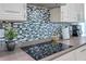 Modern kitchen featuring a sleek cooktop and stylish backsplash at 5518 72Nd E Ter, Ellenton, FL 34222