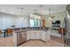 Open concept kitchen with bar seating flowing into living and dining areas at 5518 72Nd E Ter, Ellenton, FL 34222