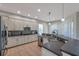 Bright kitchen with stainless steel appliances, white cabinetry, and open layout at 5518 72Nd E Ter, Ellenton, FL 34222
