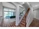 Open-concept living room with hardwood floors, staircase, and sliding glass doors to the outside at 5518 72Nd E Ter, Ellenton, FL 34222