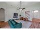 This living room has an electric fireplace, ceiling fan, and staircase at 5518 72Nd E Ter, Ellenton, FL 34222