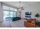 Bright living room featuring vaulted ceiling, ceiling fan, fireplace and sliding glass doors to outdoor patio at 5518 72Nd E Ter, Ellenton, FL 34222