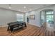 Spacious meeting room with wood flooring, recessed lighting, view of the outdoor area, and a black table at 5518 72Nd E Ter, Ellenton, FL 34222
