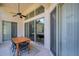 Covered patio with a ceiling fan and dining table, offering a serene outdoor space for entertaining at 5518 72Nd E Ter, Ellenton, FL 34222