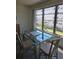 Dining room area featuring a glass table and great natural light from the window at 5623 80Th N St # 306, St Petersburg, FL 33709