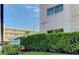 Condominium building with lush green landscaping and building sign at 5623 80Th N St # 306, St Petersburg, FL 33709