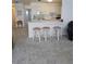 Cozy kitchen features white cabinets and barstool seating at 5623 80Th N St # 306, St Petersburg, FL 33709