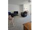 Living room area featuring plush furniture and a spacious seating arrangement at 5623 80Th N St # 306, St Petersburg, FL 33709
