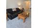 Spacious living room features comfortable seating, a coffee table, and soft carpeting at 5623 80Th N St # 306, St Petersburg, FL 33709