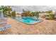 Community pool featuring crystal clear water and a relaxing seating area at 5623 80Th N St # 306, St Petersburg, FL 33709