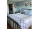 Bedroom with metal bed frame, blue accents, and a closet at 6080 80Th N St # 409, St Petersburg, FL 33709