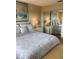 Bedroom featuring a large bed, artwork, and a sliding door closet at 6080 80Th N St # 409, St Petersburg, FL 33709