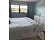 Bedroom view with a large window, neutral walls, and modern dressers at 6080 80Th N St # 409, St Petersburg, FL 33709