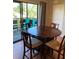 Warm dining area featuring a wooden table, chairs, and access to an outdoor balcony at 6080 80Th N St # 409, St Petersburg, FL 33709