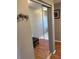 Hallway featuring mirrored closet doors, bench, and decor hooks at 6080 80Th N St # 409, St Petersburg, FL 33709