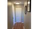 Hallway with wood-look flooring and a bi-fold closet door at 6080 80Th N St # 409, St Petersburg, FL 33709