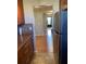 Hallway from the kitchen with wood-look flooring and a black front door at 6080 80Th N St # 409, St Petersburg, FL 33709