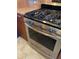 Stainless steel Frigidaire gas range and oven with wood-look lower cabinets at 6080 80Th N St # 409, St Petersburg, FL 33709