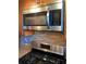 Stainless steel Frigidaire microwave above a stainless steel gas cooktop at 6080 80Th N St # 409, St Petersburg, FL 33709