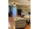 View of living room area showcasing chair and ottoman, neutral colors, and an adjacent dining area at 6080 80Th N St # 409, St Petersburg, FL 33709