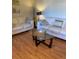 Bright living room features matching sofas, a glass coffee table, and plenty of natural light at 6080 80Th N St # 409, St Petersburg, FL 33709