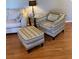 Living room seating area with an armchair, ottoman, and patterned fabric upholstery at 6080 80Th N St # 409, St Petersburg, FL 33709