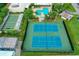 Aerial view of tennis courts with a community pool and shuffleboard in the background at 6080 80Th N St # 409, St Petersburg, FL 33709