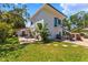 Large backyard featuring lush grass, patio area, lounge chairs, and an external staircase at 6213 12Th S Ave, Gulfport, FL 33707