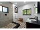 Bathroom featuring a walk-in shower, star-patterned tile floor, and a dark vanity at 6213 12Th S Ave, Gulfport, FL 33707