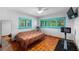 Bright bedroom with unique flooring, complemented by turquoise window frames and a ceiling fan at 6213 12Th S Ave, Gulfport, FL 33707