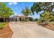 Charming home featuring a red tile roof, well-manicured landscaping, and a circular driveway at 6213 12Th S Ave, Gulfport, FL 33707