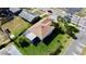 An aerial view showing the backyard with landscaping, enclosed porch, and surrounding neighborhood at 6446 Louisiana Ave, New Port Richey, FL 34653