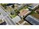 Overhead aerial view of house showing landscaping, surrounding neighborhood, and nearby pond at 6446 Louisiana Ave, New Port Richey, FL 34653