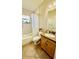 Cozy bathroom featuring a shower-tub combo and vanity with natural wood cabinets at 6446 Louisiana Ave, New Port Richey, FL 34653