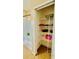 Bathroom showing shower and closet storage space with shelves at 6446 Louisiana Ave, New Port Richey, FL 34653